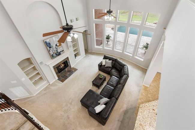 Soaring 2 story ceiling in family room with fantastic views to nature and your own private pool. | Image 26