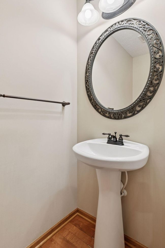 The main level half bath is just off the kitchen | Image 8