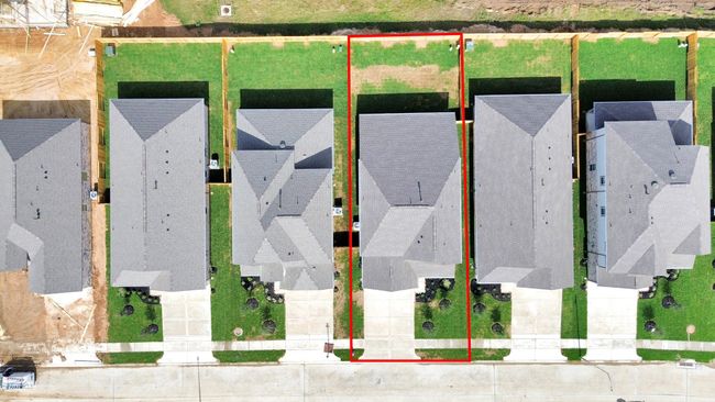 This home sits on a large lot with ample yard space in front and the back, lush landscaping and a well-maintained yard. | Image 4