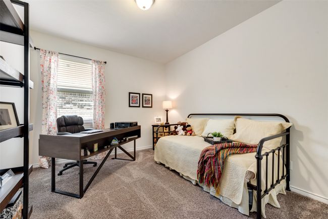 Carpeted bedroom featuring baseboards and a desk | Image 22