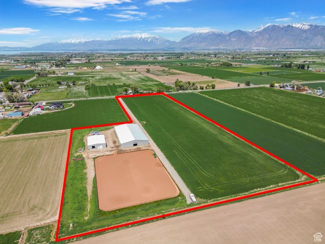 Aerial view of sparsely populated area featuring property boundaries highlighted and a mountain backdrop | Image 31