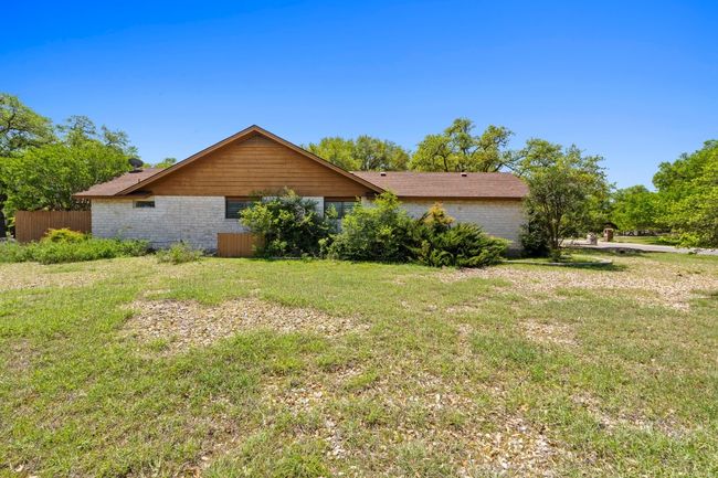 View of home's exterior featuring fence and a lawn | Image 25