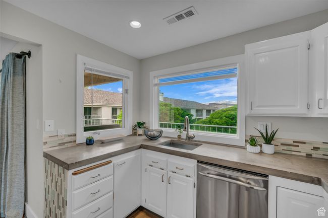 Kitchen featuring dishwasher, a sink, white cabinets, and recessed lighting | Image 16