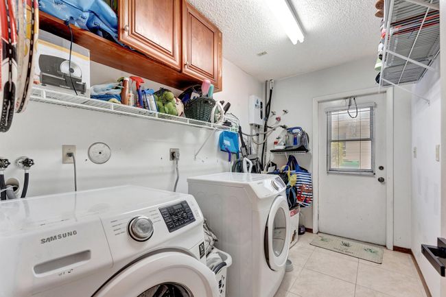Laundry Room off hallway to guest bath, 2 car garage with pedestrian door to side of home. | Image 28