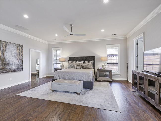 Bedroom featuring multiple windows, crown molding, dark wood-style flooring, recessed lighting, and ceiling fan | Image 19