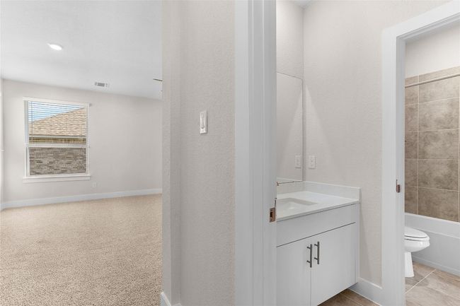 Bathroom featuring vanity, toilet, shower / washtub combination, and baseboards | Image 25