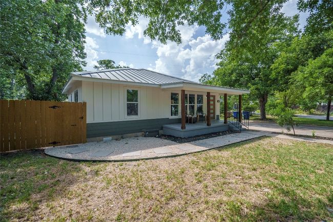 Back of house featuring crawl space, a metal roof, a standing seam roof, and board and batten siding | Image 34