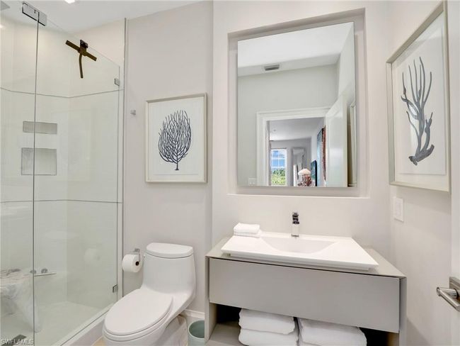 Bathroom with toilet, vanity, and a stall shower | Image 12