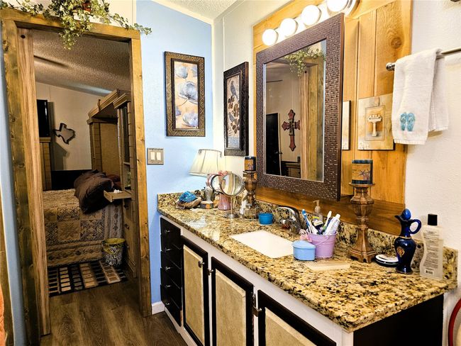 Bathroom with wood finished floors, a textured ceiling, and vanity | Image 12