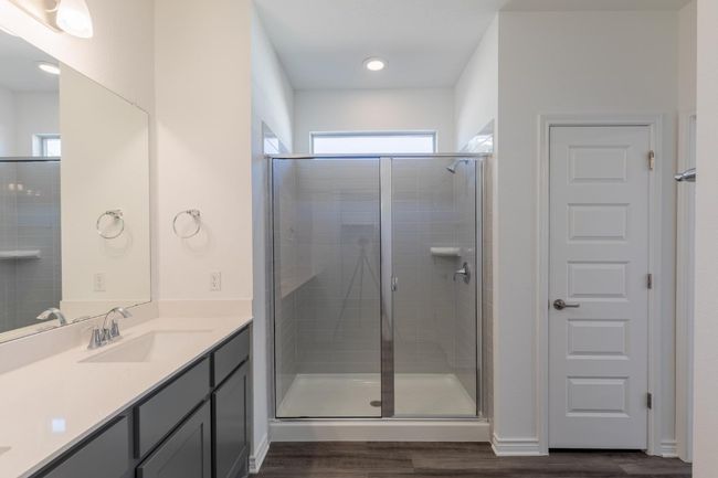 Full bathroom featuring a stall shower, plenty of natural light, and wood finished floors | Image 22
