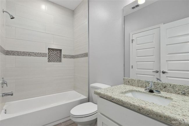 Full bathroom featuring vanity and bathtub / shower combination | Image 12