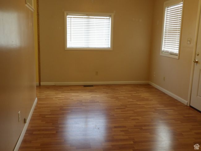 Dining room with a wealth of natural light and wood-type flooring | Image 11