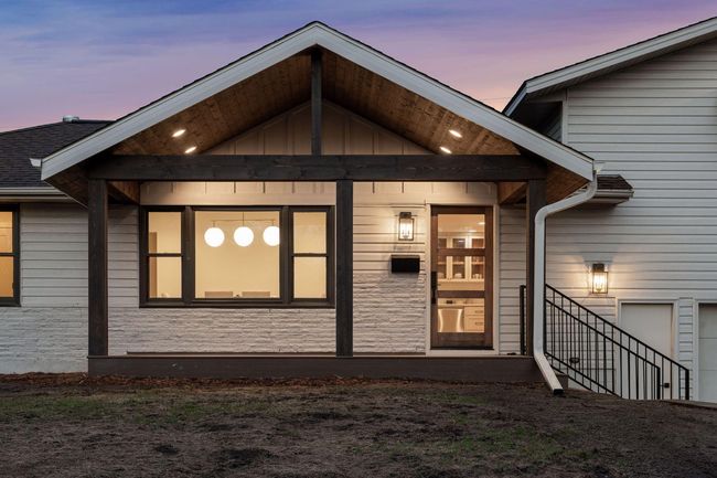 Beautiful front porch & custom wood front door is sure to make a statement for your guests. | Image 4