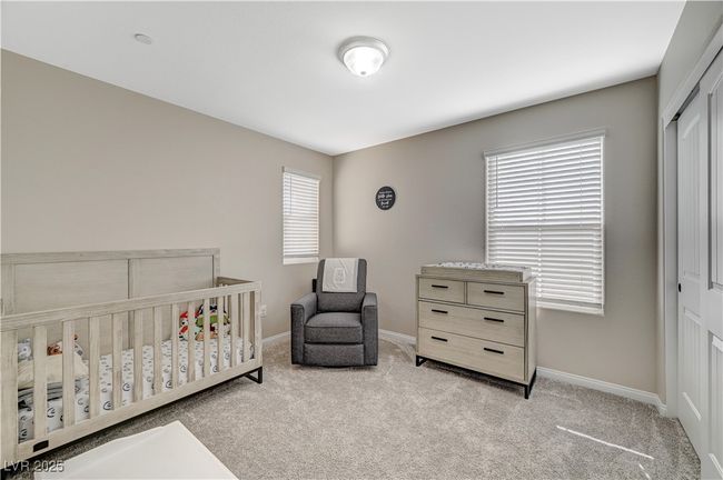 Carpeted bedroom featuring a closet, baseboards, and a crib | Image 46