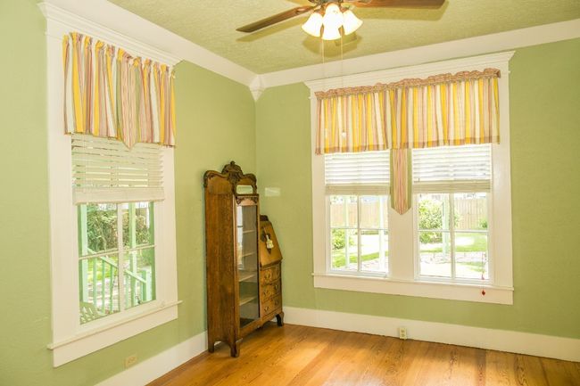 Empty room featuring a ceiling fan, wood finished floors, and a textured ceiling | Image 16