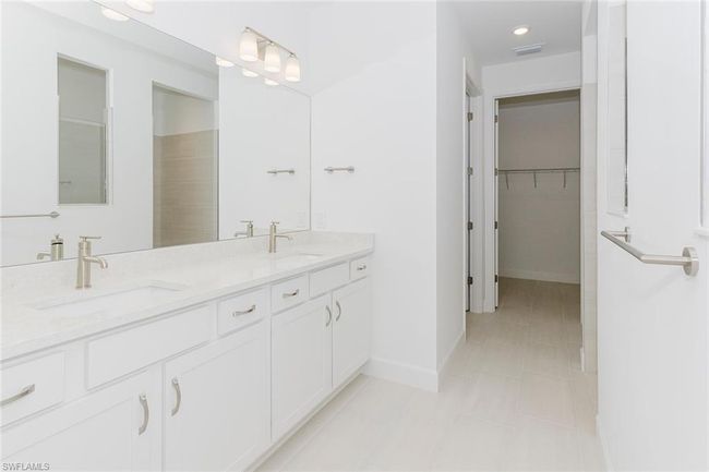 Full bath with double vanity, a spacious closet, tile patterned flooring, and recessed lighting | Image 21