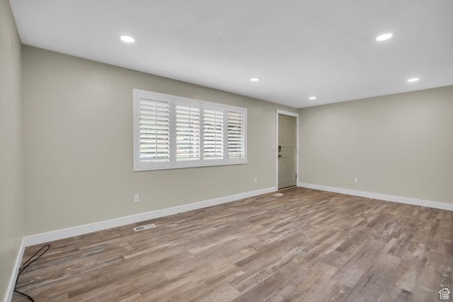 Spare room with visible vents, baseboards, recessed lighting, and wood finished floors | Image 9