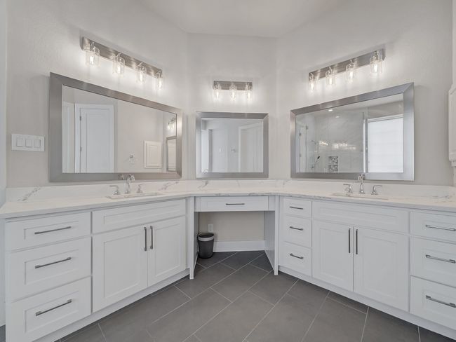 Bathroom with a stall shower, vanity, and tile patterned floors | Image 13
