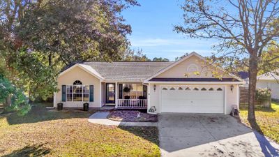 Ranch-style home with a front yard and a garage | Image 3