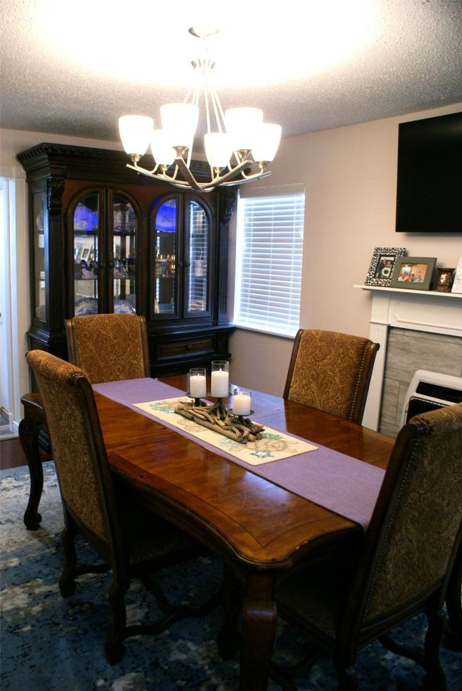 Dining space with a chandelier and a textured ceiling | Image 9