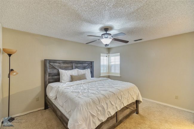 This room is large enough to have a king size bed and plenty of room around the bed. | Image 27