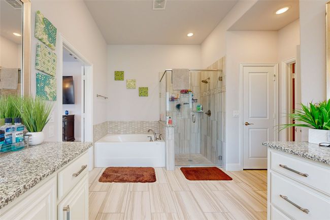 Full bath featuring a garden tub, visible vents, a stall shower, and vanity | Image 35