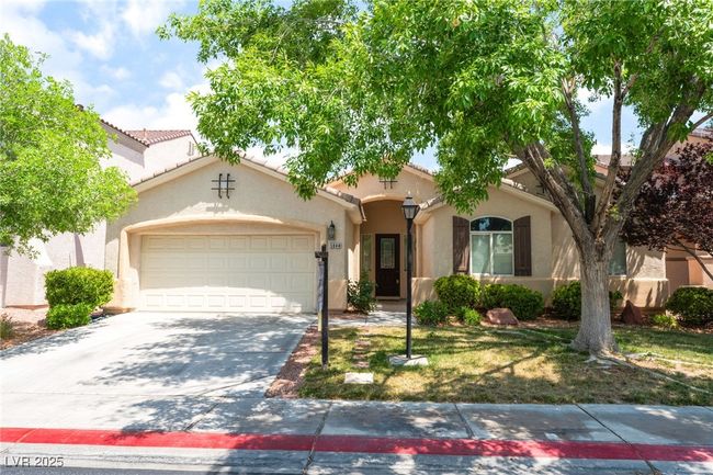 Mediterranean / spanish-style house with an attached garage, driveway, stucco siding, and a tile roof | Image 5