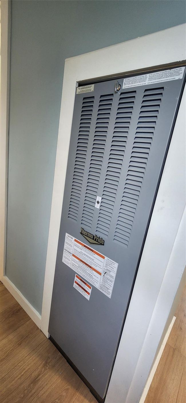 Interior details with wood finished floors, a heating unit, and baseboards | Image 39