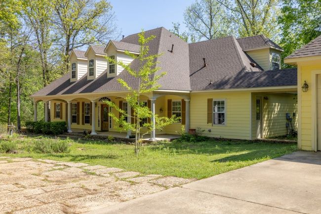 Cape cod house with a front lawn, covered porch, and roof with shingles | Image 12