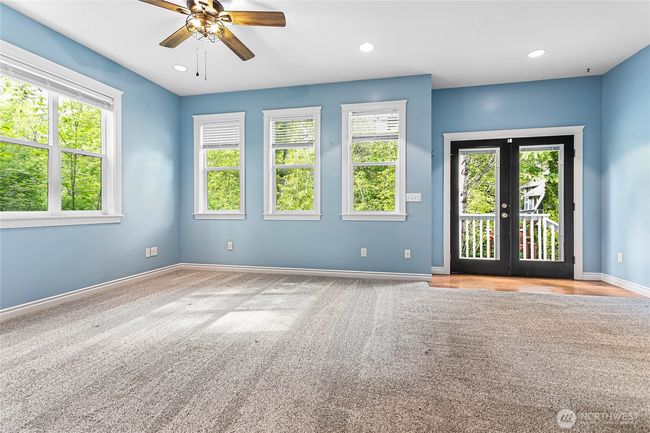 This space is massive. Enough room for a living space and sitting area. Those French doors lead to a small deck and fully-fenced private patio with an exit to the driveway. | Image 27