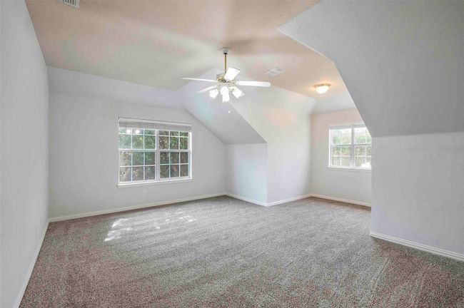 Bonus room with carpet flooring, baseboards, visible vents, a ceiling fan, and lofted ceiling | Image 17