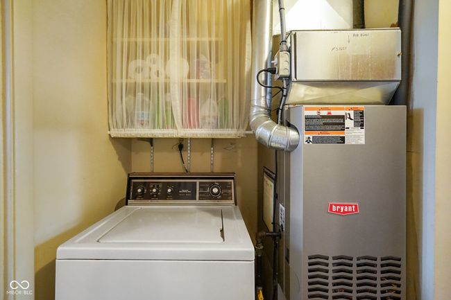 laundry area featuring washer / dryer and heating unit | Image 29