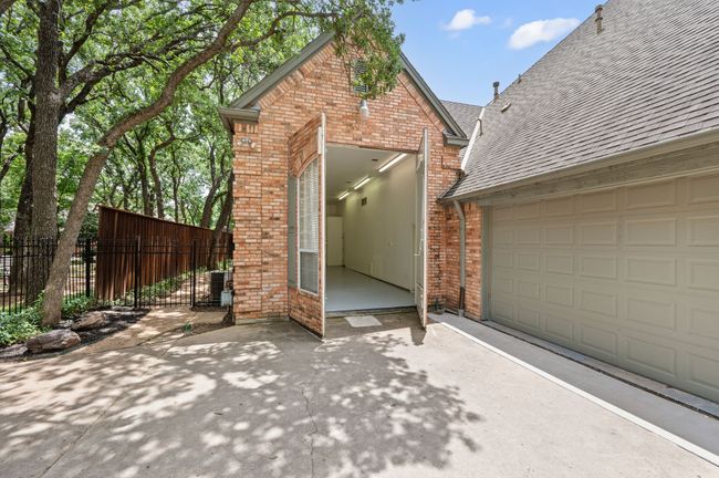 Hidden bricked RV garage doors open to the gated driveway | Image 34