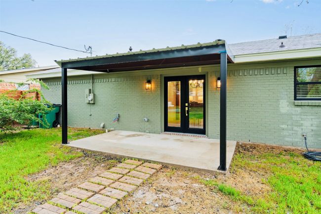 Rear view of property featuring a patio area, brick siding, and a lawn | Image 36