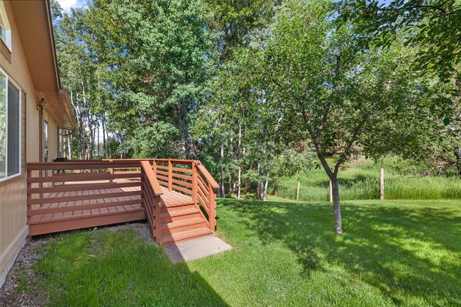 View of grassy yard featuring a deck | Image 33