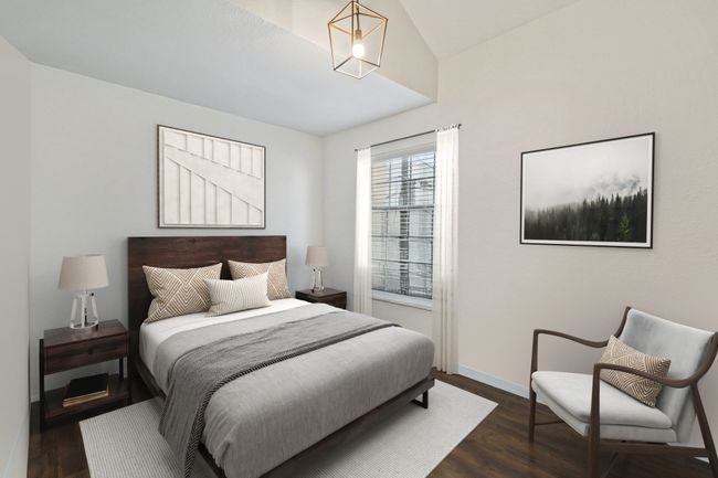 Bedroom with vaulted ceiling lots of natural light and decorative light fixture | Image 12