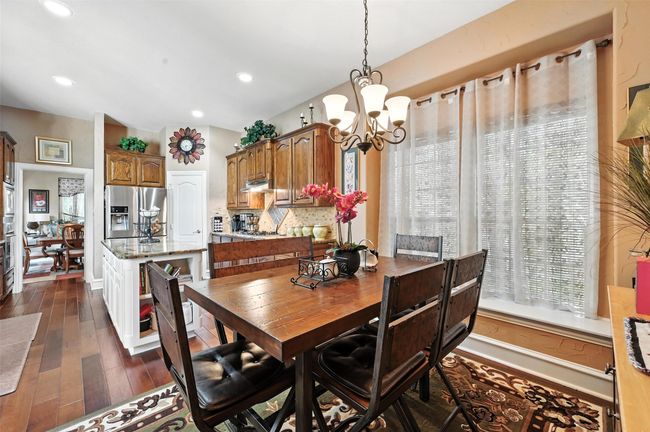 Dining space featuring a chandelier, dark wood finished floors, and recessed lighting | Image 8
