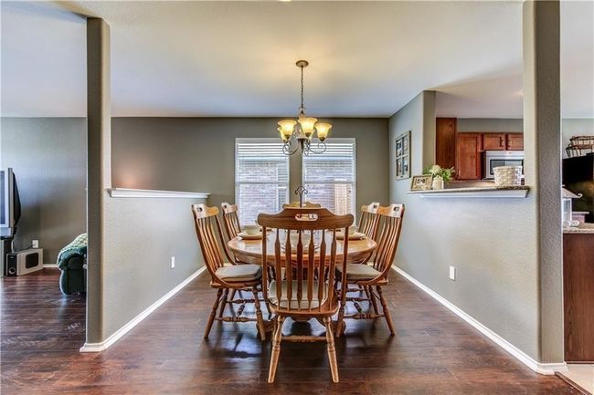 Dining area with a chandelier and dark wood-style floors | Image 6