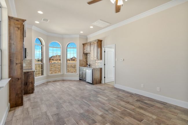 Unfurnished living room with crown molding, light wood-type flooring, ceiling fan, recessed lighting, and baseboards | Image 27