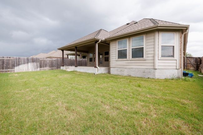 Back of property with a fenced backyard and a shingled roof | Image 31