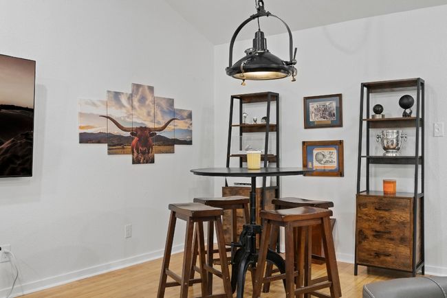 Dining space featuring light wood-type flooring, baseboards, and lofted ceiling | Image 14