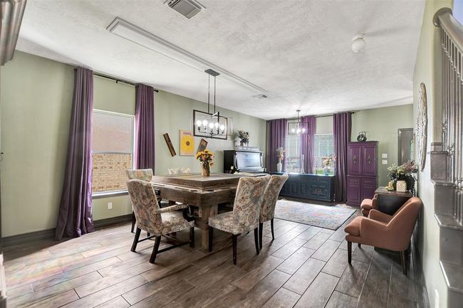 View into the elegant dining and living area through the charming barn door. | Image 7