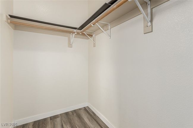 Walk in closet featuring dark wood-type flooring | Image 16