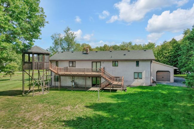 Large deck and gazebo, as well as a 4th garage door out the back of the 3rd stall of the attached garage. | Image 28