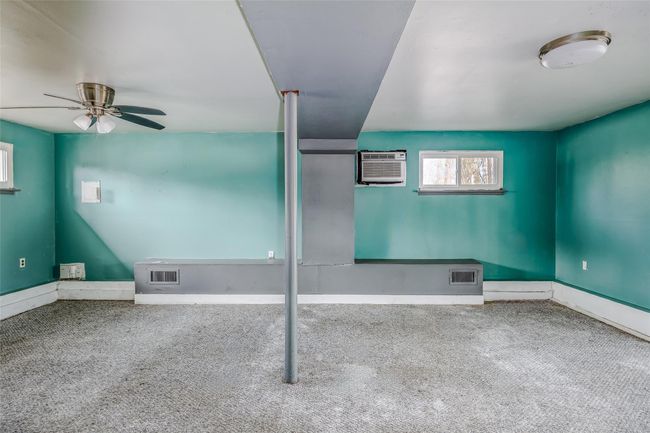 Unfurnished room featuring carpet floors, a wall mounted air conditioner, ceiling fan, and visible vents | Image 27