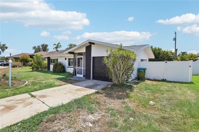 View of front of house featuring a garage and a front yard | Image 3