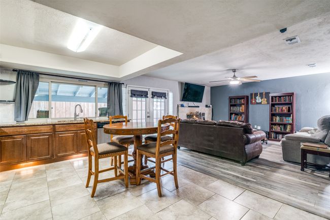 Dining room with ceiling fan, a textured ceiling, and light wood-type flooring | Image 11