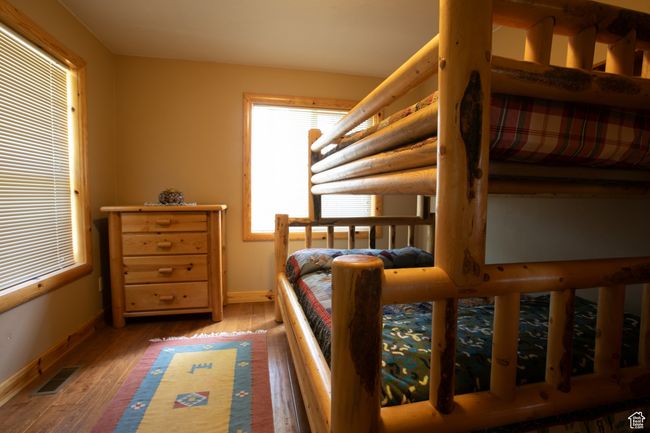 Bedroom featuring baseboards and wood finished floors | Image 21