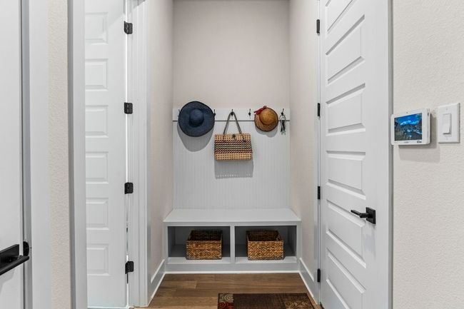 Mudroom with dark wood-style floors and baseboards | Image 5