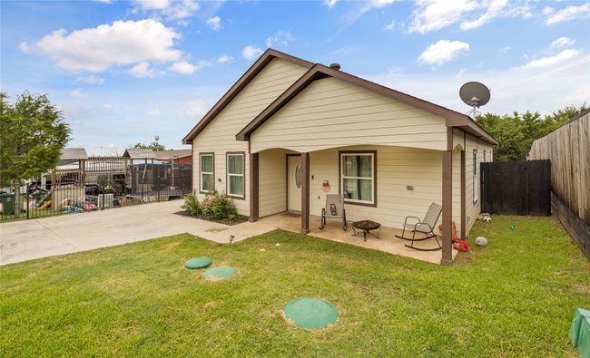 View of front of property with a patio, a fenced backyard, and a fire pit | Image 6